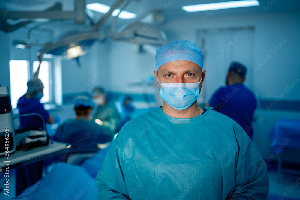 Portrait of the professional surgeon. Doctor wearing mask. Medicinal sitting near professional equipment. Portrait of the professional surgeon. Doctor wearing mask. Medicinal sitting near professional equipment.