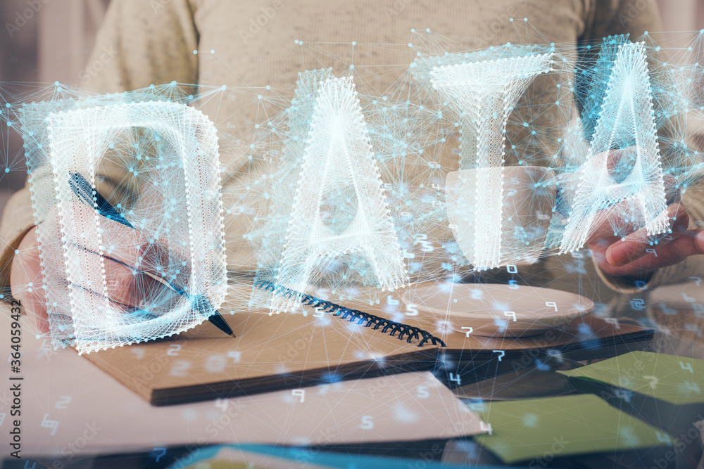 Double exposure of writing hands on background with data solution hologram on front. Technology concept. Side view. Double exposure of writing hands on background with data solution hologram on front. Technology concept. Side view.