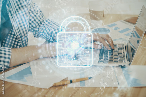 Double exposure of lock icon with man working on computer on background. Concept of network security.