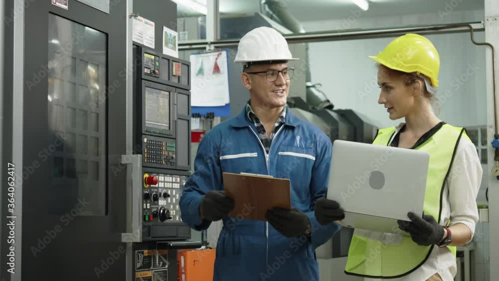 Construction or technician worker working in the factory with machine. Protective equipment such as hard hat and safety work clothes. Quality of production staff. Concept Team work Construction or technician worker working in the factory with machine. Protective equipment such as hard hat and safety work clothes. Quality of production staff. Concept Team work