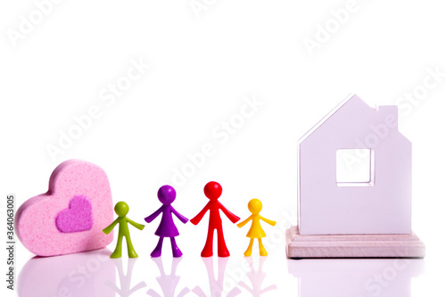 Happy family concept. Family figures, pink heart and white house on isolate photo