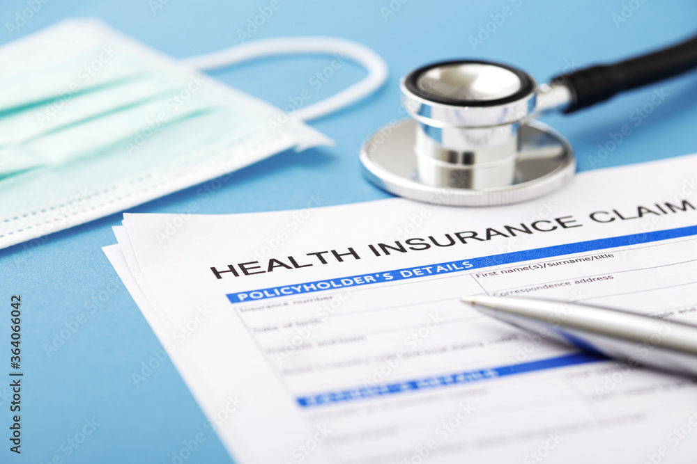 Health insurance document with stethoscope Health insurance document with stethoscope