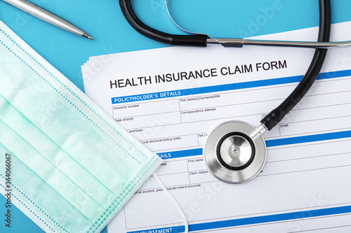 Slika na platnu Health insurance claim form with stethoscope and surgical mask