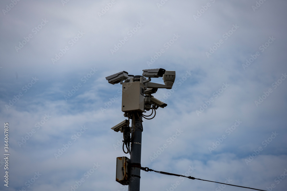 complex of security cameras in a recreation park against the sky complex of security cameras in a recreation park against the sky