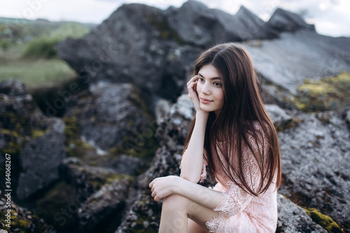 Young brunette girl portrait outdoors in grey mountains outdoors. Woman beauty concept © Andreshkova Nastya
