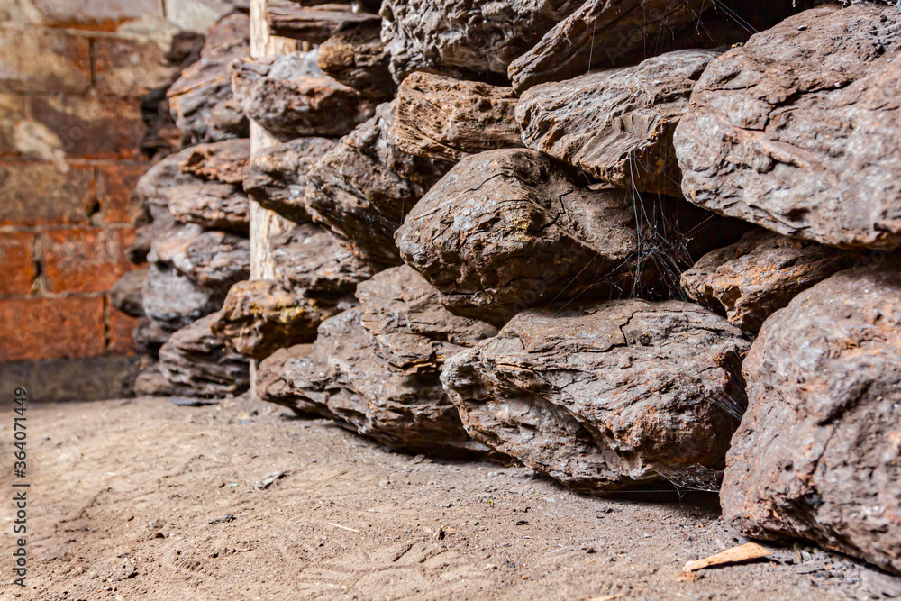 Fototapeta premium Dry charcoal pile stacked in basement
