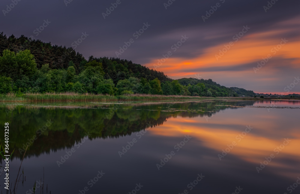 Fantastic beautiful sunset evening view on lake in Stradch, Lviv district. june 2020. Long exposure shot.