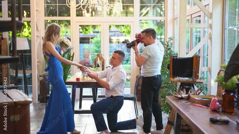 photo shoot proposal of marriage. photographer and lovers on a romantic dinner. photo shoot proposal of marriage. photographer and lovers on a romantic dinner.