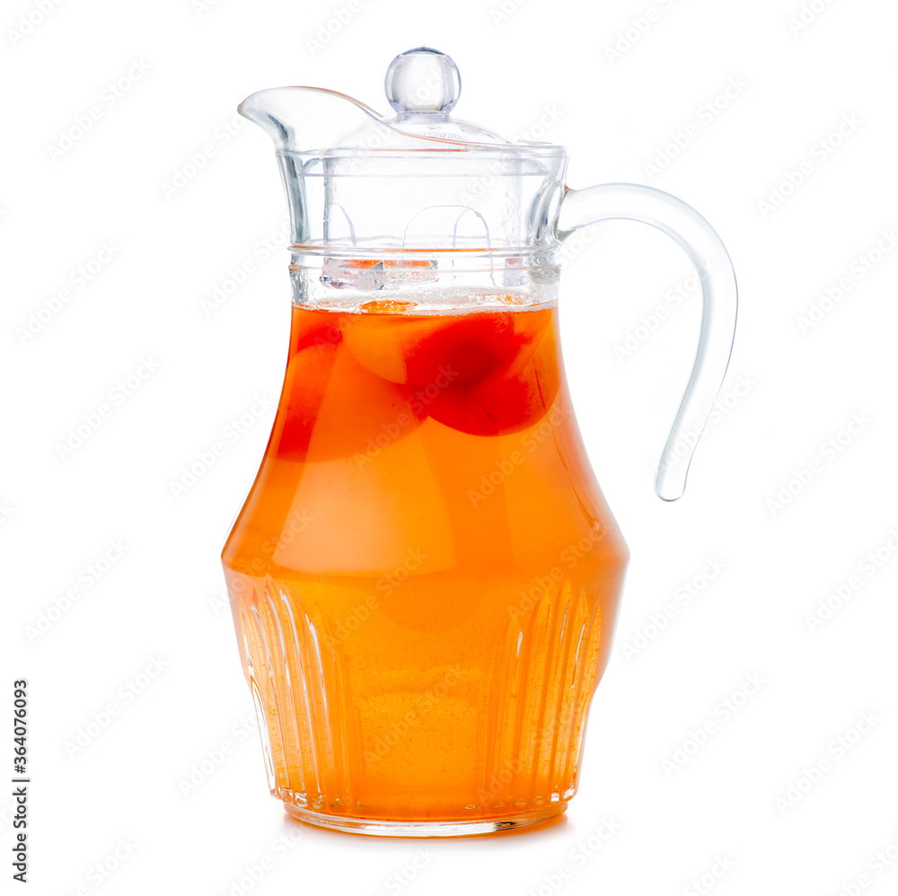 Glass carafe jug with apricot compote on white background isolation Glass carafe jug with apricot compote on white background isolation