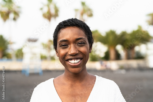 Smiling African woman portrait - Happy black female having fun posing in front of camera