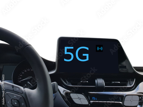 Concept of 5G cellular vehicle communications. Car front display panel with the text 5G and wireless connectivity symbol.
