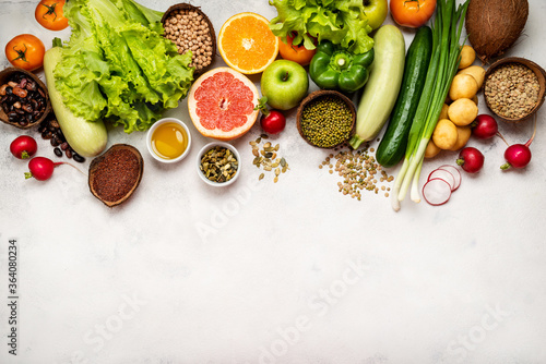 Vegan healthy food border on white background. Top view with place for text.