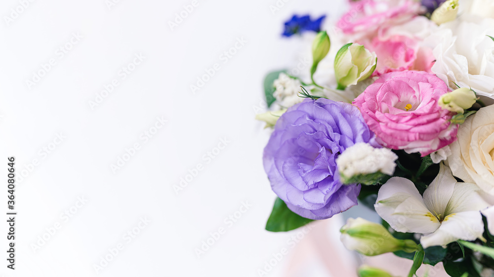 beautiful bouquet of multi-colored eustomas close-up, copy space. Focus on the petals, white background blurred