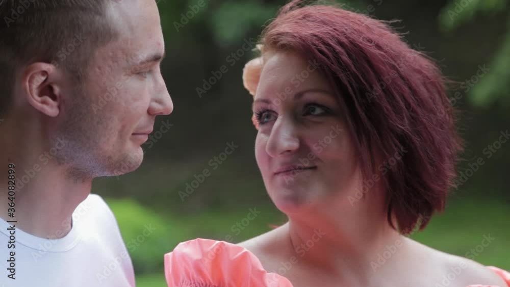 Loving couple in the park looking at each other at the fountain. Loving couple in the park looking at each other at the fountain.