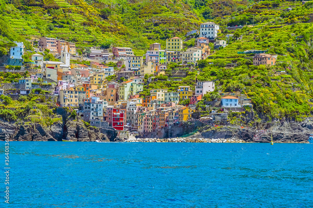 A close-up view of the Cinque Terre, fishing village of Riomaggiore, Italy and surrounding cliffs in summertime