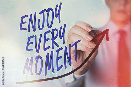 Writing note showing Enjoy Every Moment. Business concept for stay positive thinking for an individualal development Digital arrowhead curve denoting growth development concept photo