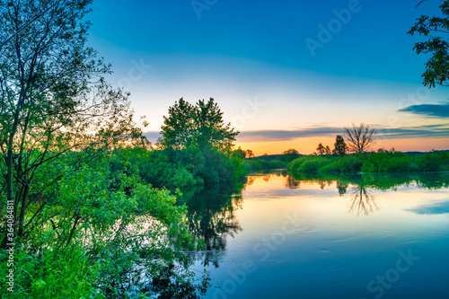 Lake water sunset and nature autumn landscape with blue sky
