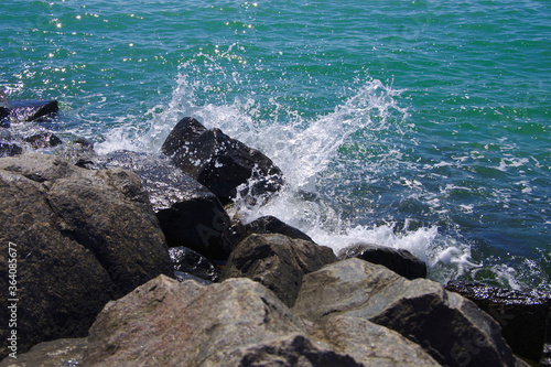 Waves breaking on large stones on the coast.