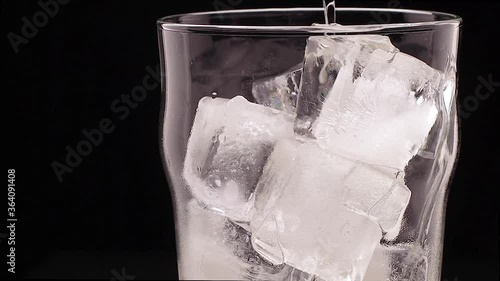 glass with ice filled with ginger ale