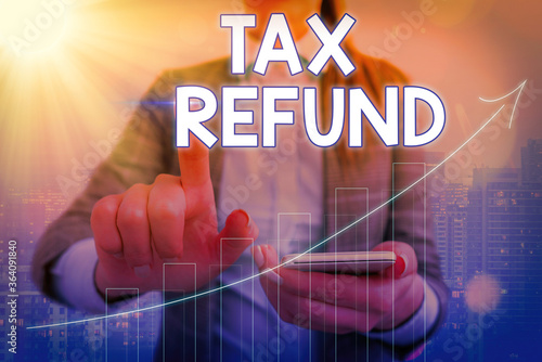 Conceptual hand writing showing Tax Refund. Concept meaning excess payment of paid taxes returned to business owners Arrow symbol going upward showing significant achievement photo