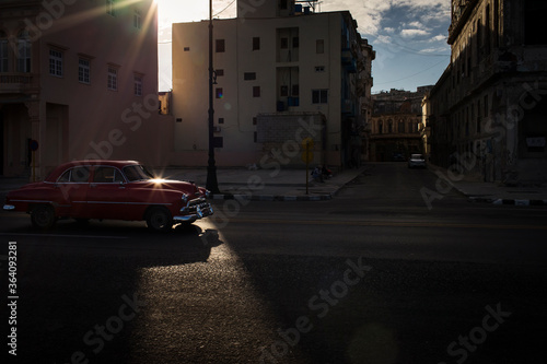 Old car on Malecon street of Havana with beautiful buildings in background. Cuba © danmir12