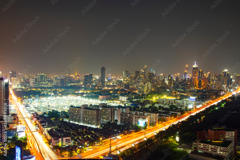 Fototapeta premium Cityscape with sunset over the building and blue sky at bangkok ,Thailand. View of the tall building in capital with twilight.