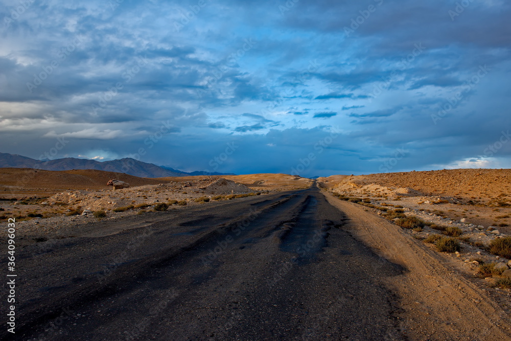 Tajikistan. Dramatic evening sky over the Pamir highway in the area of the high-altitude lake Bulunkul. Tajikistan. Dramatic evening sky over the Pamir highway in the area of the high-altitude lake Bulunkul.