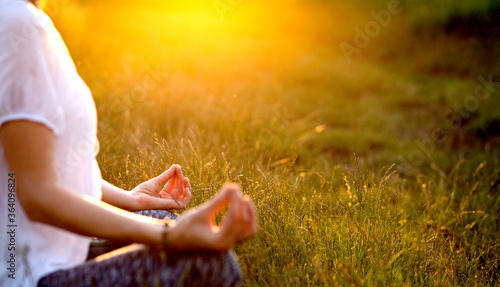 woman in a yoga pose at sunset by lakeside mindfulness and mental health