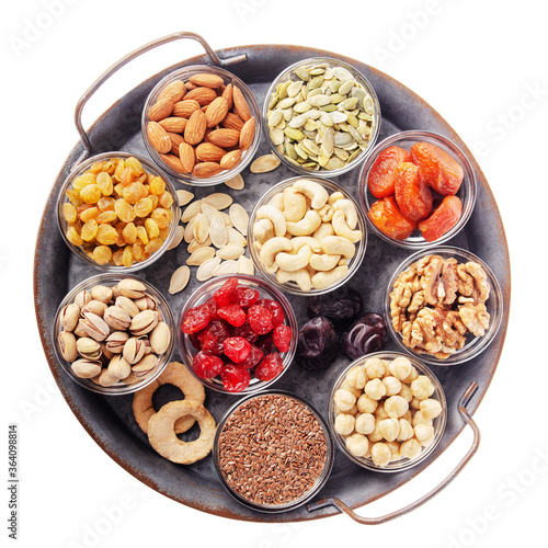 Flat lay at metal tray with healthy ant tasty non-perishables isolated on white background