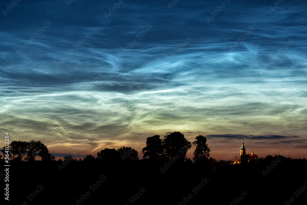 Rare noctilucent clouds at summer night sky