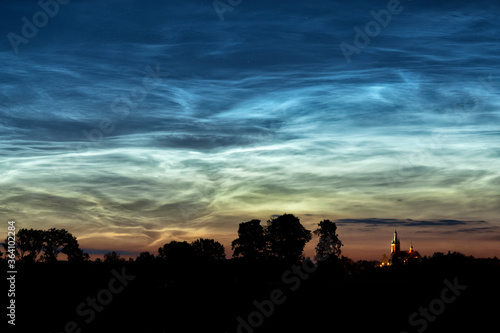 Rare noctilucent clouds at summer night sky