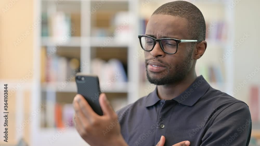 Portrait of Upset Young African Man having Loss on Smartphone Portrait of Upset Young African Man having Loss on Smartphone