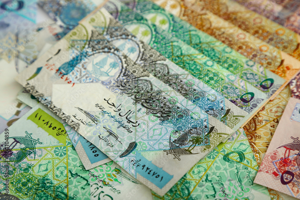 Currencies and money exchange trading concepts. Qatari 500 ,100,50,10,5,1 Riyals Bank Note .& Coins ,Qatari Currency roll Currencies and money exchange trading concepts. Qatari 500 ,100,50,10,5,1 Riyals Bank Note .& Coins ,Qatari Currency roll
