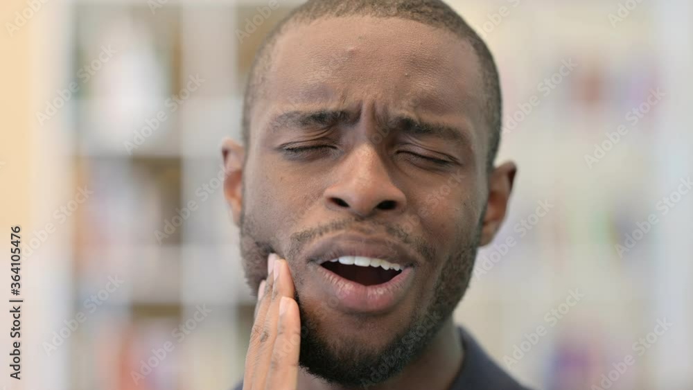 Close up of Young African Man having Toothache Close up of Young African Man having Toothache