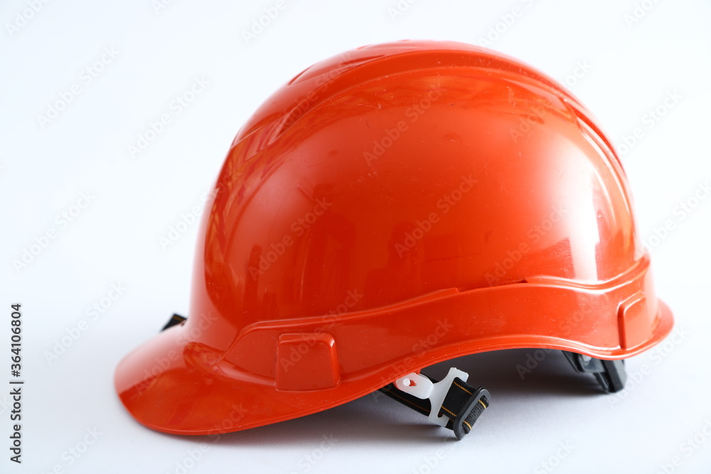Fototapeta premium Red construction helmet shot isolated on white