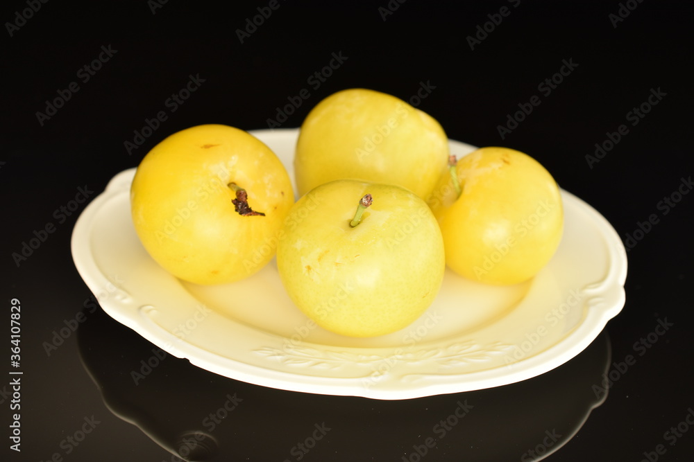 Ripe yellow plum, close-up, isolated on black.
