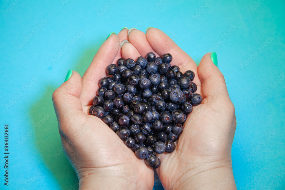 Juicy blueberries in the palm of your hand Juicy blueberries in the palm of your hand