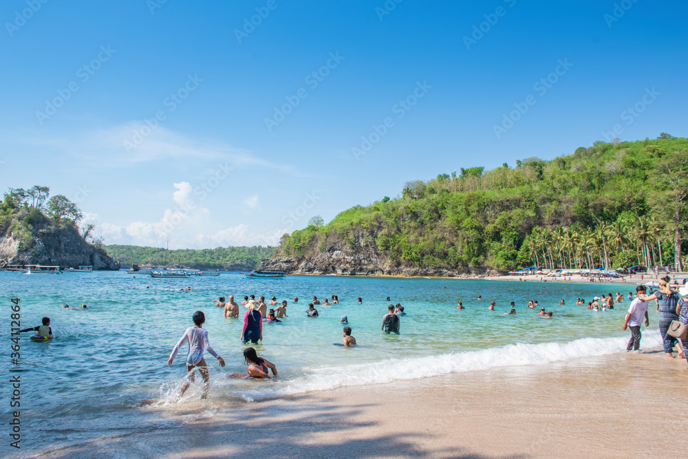 Ubud, Bali, Indonesia- 20 December, 2019 Several Tourists are enjoying seascape view of Crystal bay in Nusa penida