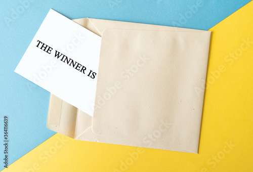 The winner is text with an envelope, competition and prize concept 