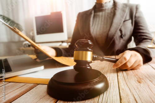 Business and lawyers discussing contract papers with brass scale on desk in office. Law, legal services, advice, justice and law concept picture with film grain effect