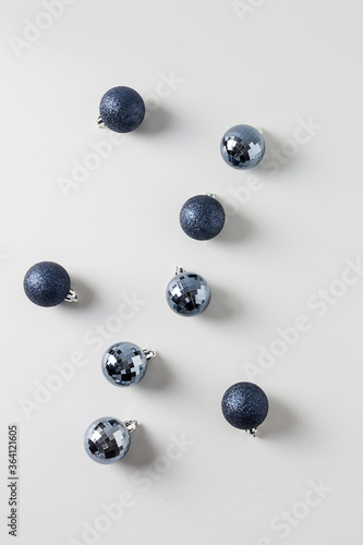 Christmas blue balls on grey. Top view. Xmas abstract pattern. Holiday greeting card.