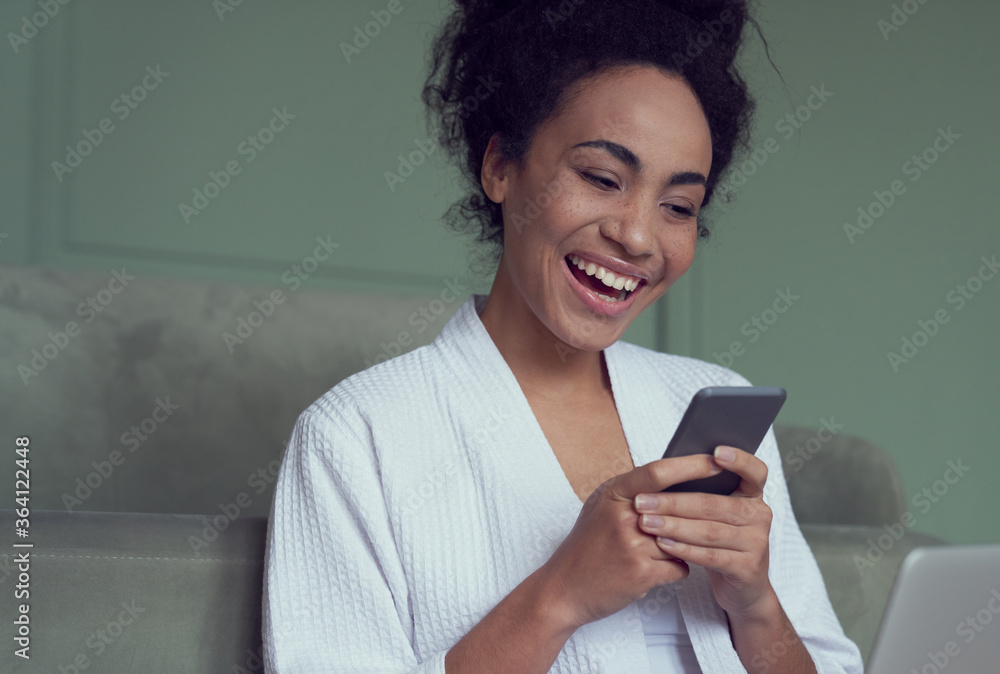 Happy young woman messaging on cell phone indoors Happy young woman messaging on cell phone indoors