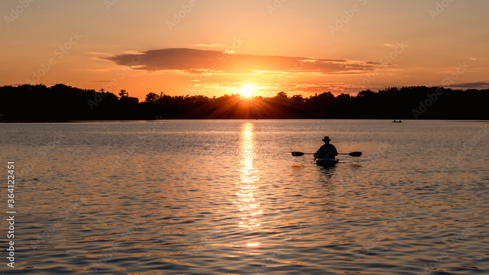 People are boating and having fun under sunset People are boating and having fun under sunset