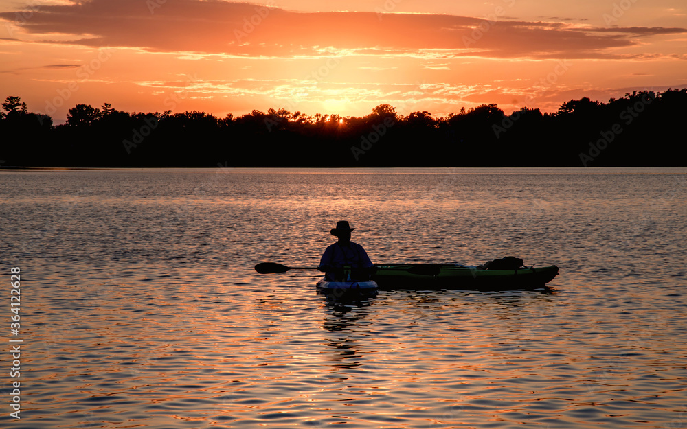 People are boating and having fun under sunset People are boating and having fun under sunset