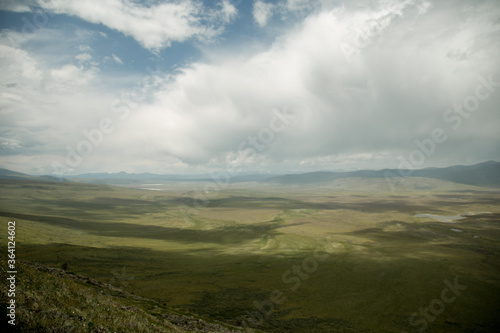 Amazing view of Altai mountain. Background of a steppe at the plateau Ukok. Russian adventures. Mountain hiking in the Altai republic. Active holiday with family and friends. Image with noise effect.