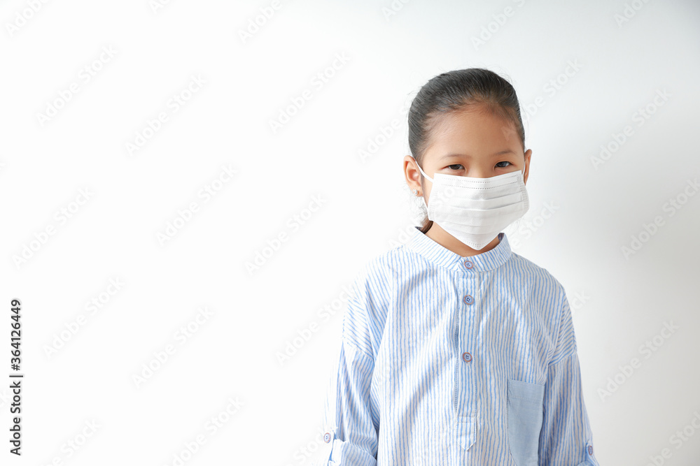 Kid girl wearing mask for protect dust pm 2.5, virus and bacteria. Protection from sprayed saliva from patients.