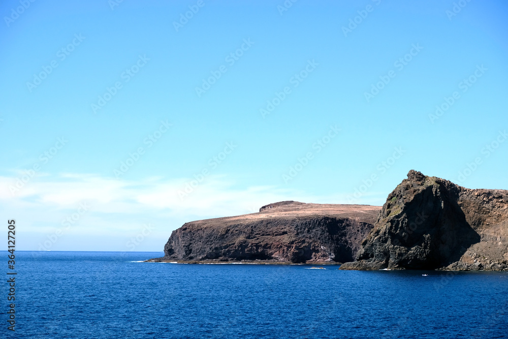Cliffs, cape, ocean and sky. Gran Canaria, Canary Islands, Spain, Africa. Large empty copy space. Cliffs, cape, ocean and sky. Gran Canaria, Canary Islands, Spain, Africa. Large empty copy space.