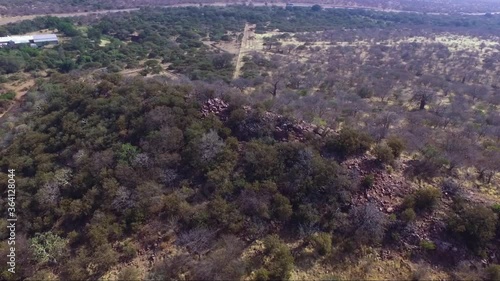 ancient ruins on an African Mapungubwe site mountain with stone walls dry grass and trees added grain noise out of focus