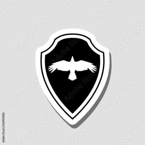 Raven bird and heraldic shield sticker isolated on gray background