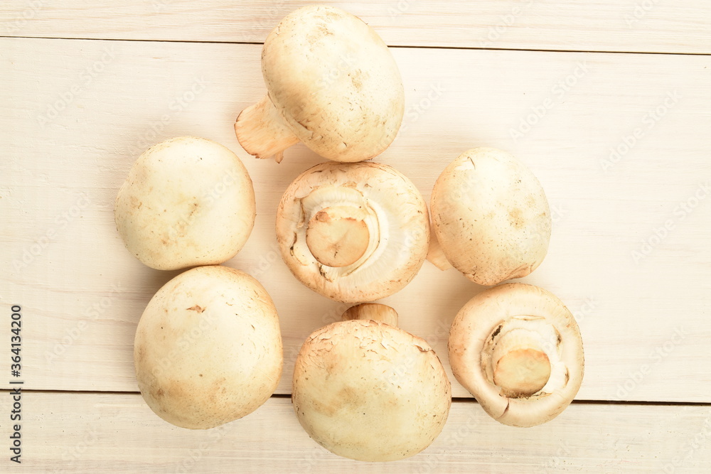 Freshly cut mushrooms, close-up, on a white wooden table. Freshly cut mushrooms, close-up, on a white wooden table.